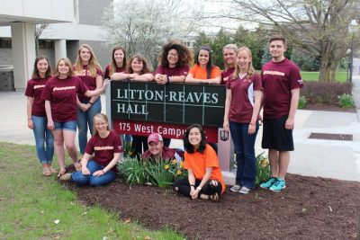 The 13 2017-2018 DASC ambassadors by the Litton-Reaves Hall sign in Hokie colors.